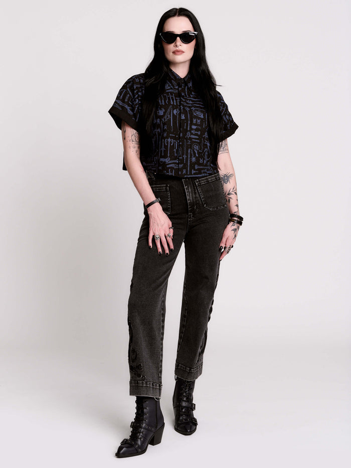 Armory Cropped Shirt is a boxy, cropped, short-sleeve button-down that mixes crisp classic shirting with dark, gothic illustration.