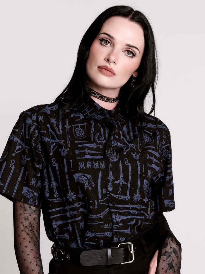 short-sleeve button-down that mixes crisp classic shirting with dark, gothic illustration.