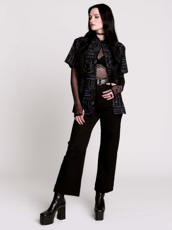 short-sleeve button-down that mixes crisp classic shirting with dark, gothic illustration.