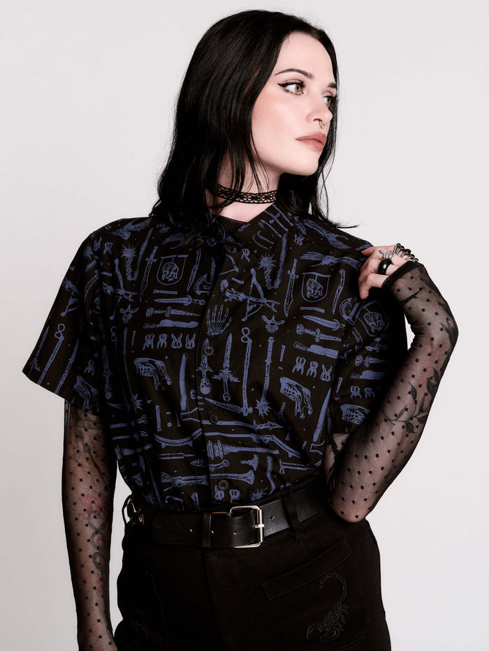 short-sleeve button-down that mixes crisp classic shirting with dark, gothic illustration.