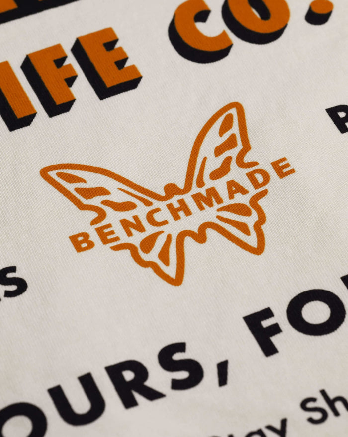 Orange Benchmade Butterfly Logo Detail - Back Graphic Close-up | Benchmade Knife Co.