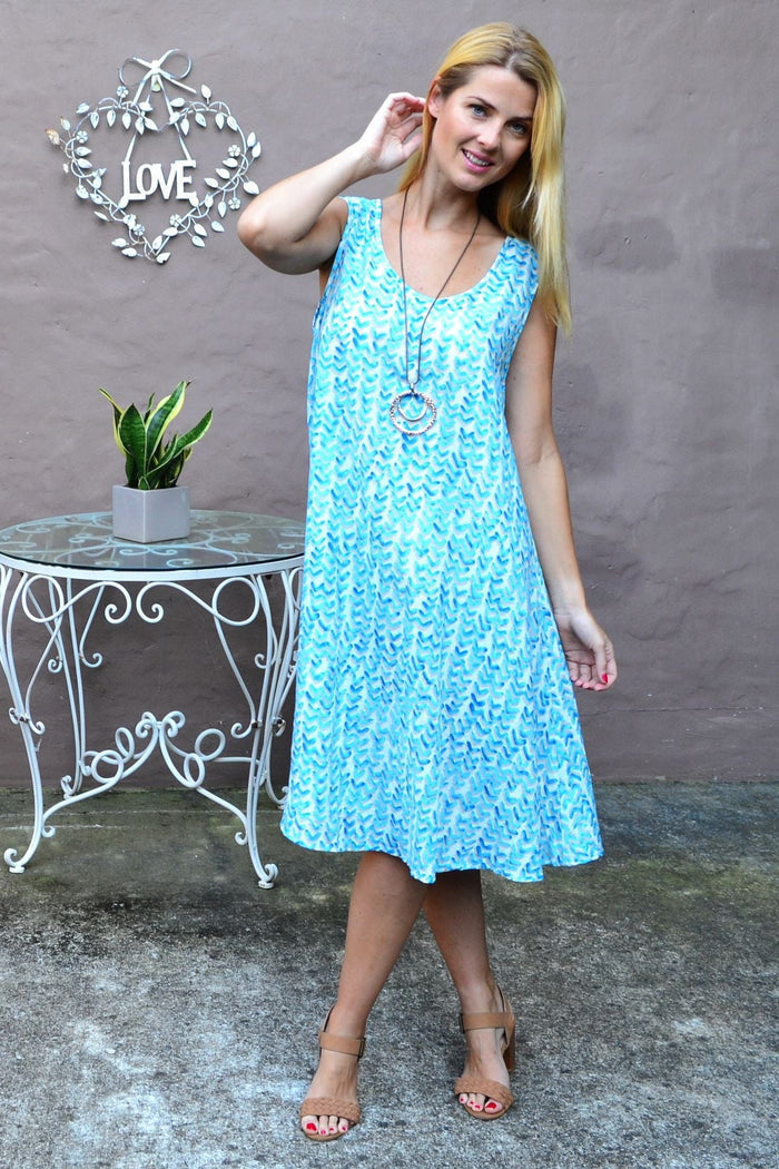 Blue boomerang print Cordelia St A-line shift tunic dress hanging on a wooden hanger, showcasing casual style and relaxed fit.