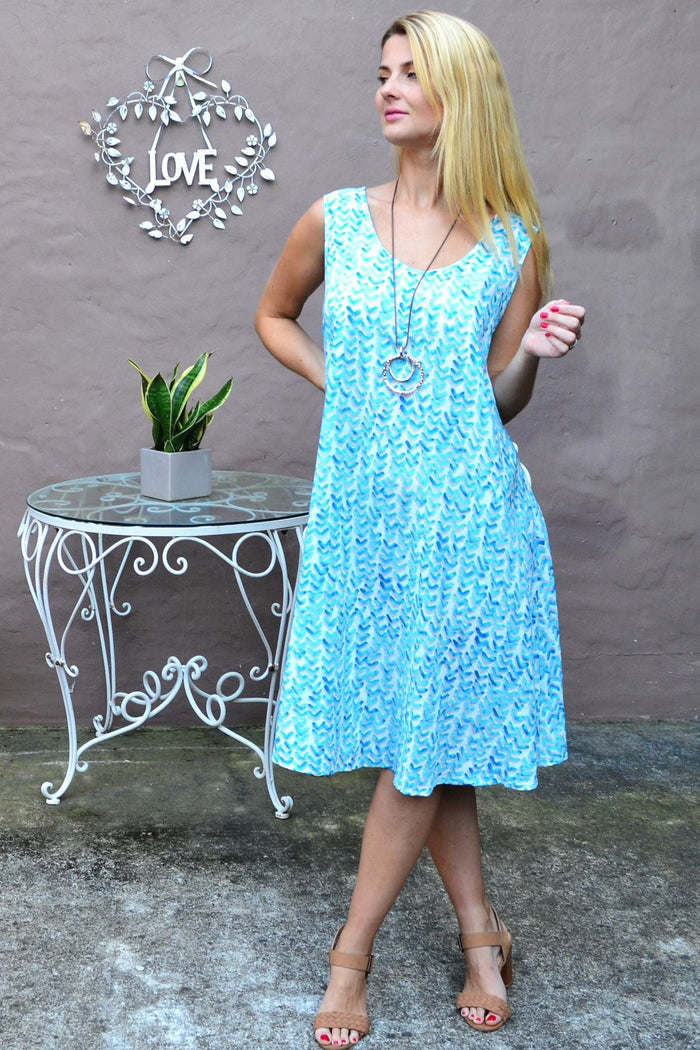 Aqua blue sleeveless Boomerang A-line shift tunic dress by Cordelia St, displayed on a model against a plain background.