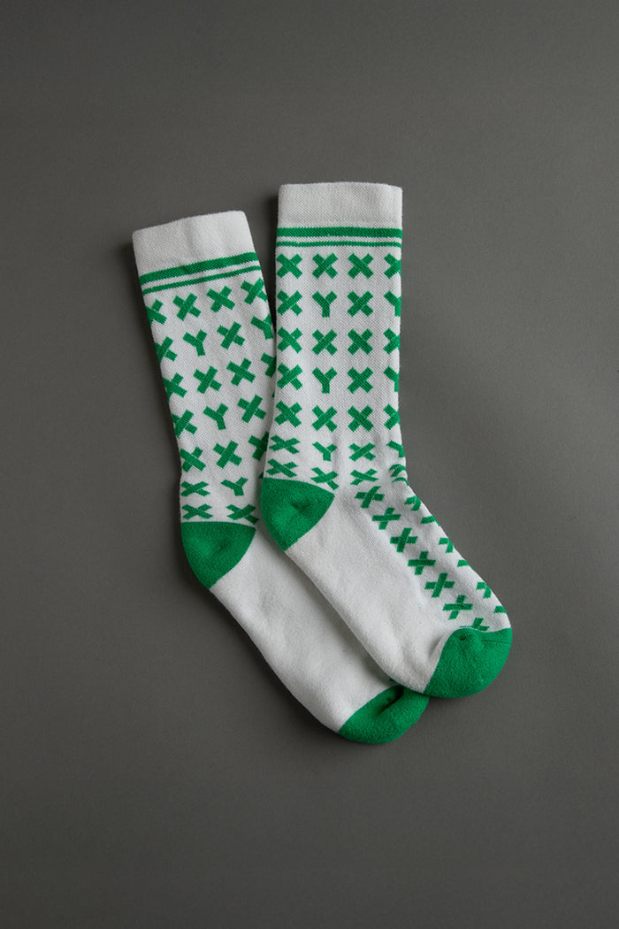 Pair of white socks with green pattern on a gray background || kelly green