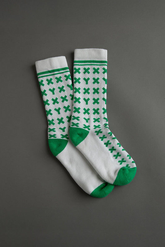 Pair of white socks with green pattern on a gray background || kelly green