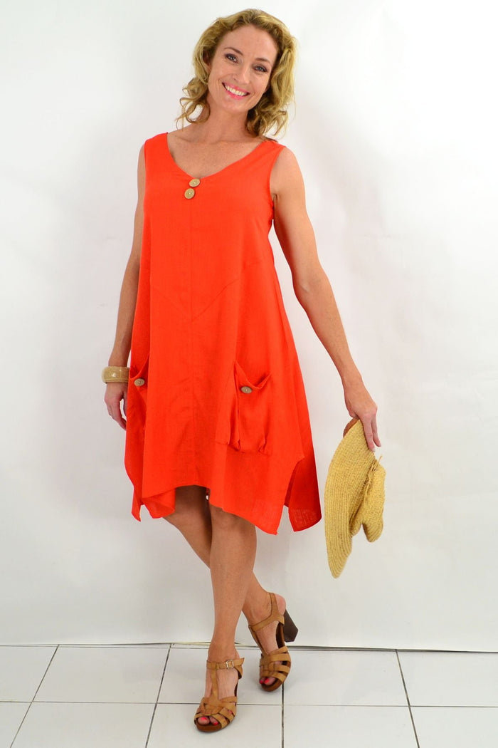 Ruby Rain Costa Rica Vivid Orange Tunic Dress hanging on a wooden hanger, showcasing its vibrant color and relaxed fit.