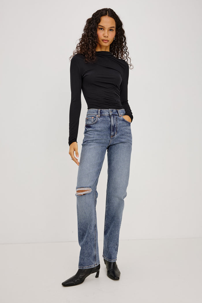 Joelle Top in Soft Jersey With High Funnel Neckline, Long Sleeves, Self-Lined Body, and Asymmetric Ruching at Shoulder and Waist in Black Colorway - Full Body Front View Featured on Model