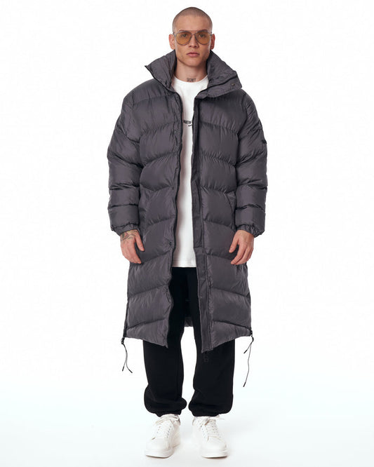 Martin Valen oversized long gray puffer coat front view with high collar raised, horizontal quilting and partially open zip