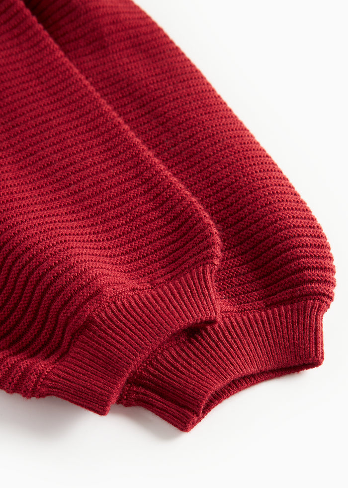 Red knitted pants with suspenders and pretty buttons for baby