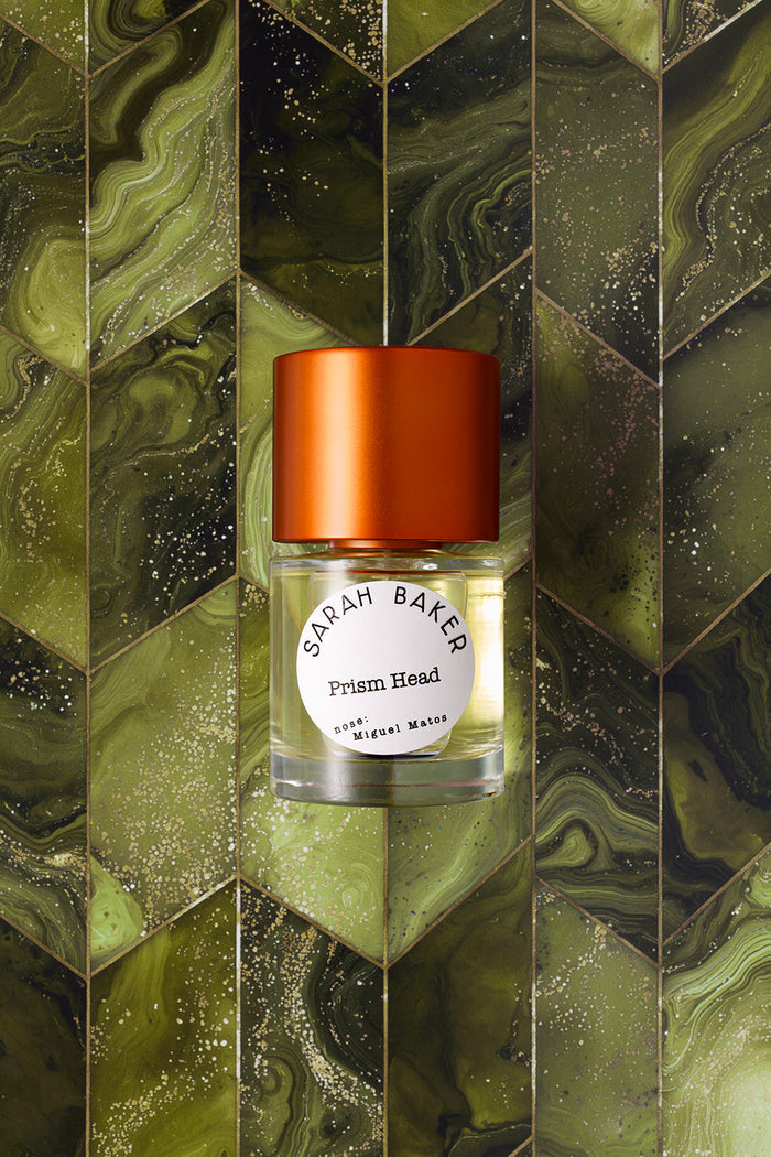 Sarah Baker Perfumes Prism Head 50ml Eau de Parfum bottle with red cap on green marbled chevron tile background