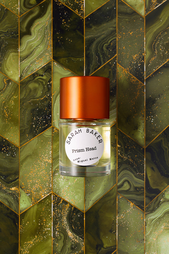 Sarah Baker Perfumes Prism Head 50ml Eau de Parfum bottle with red cap on green marbled chevron tile background
