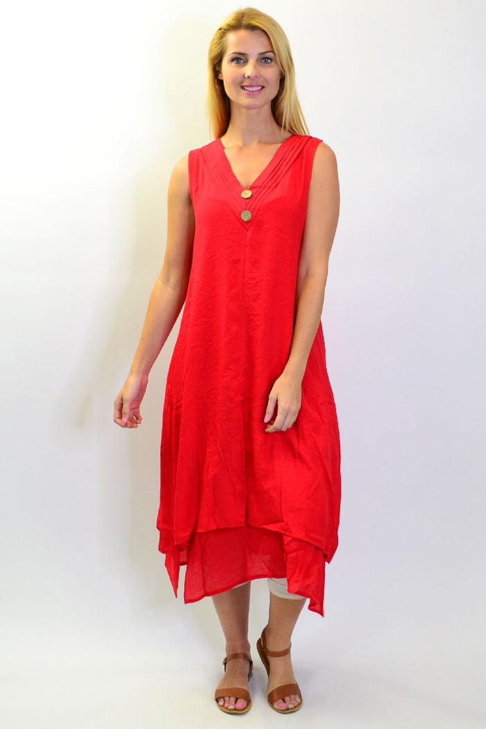 Red sleeveless cotton tunic dress with coconut buttons from La Mode, displayed on a dress form.