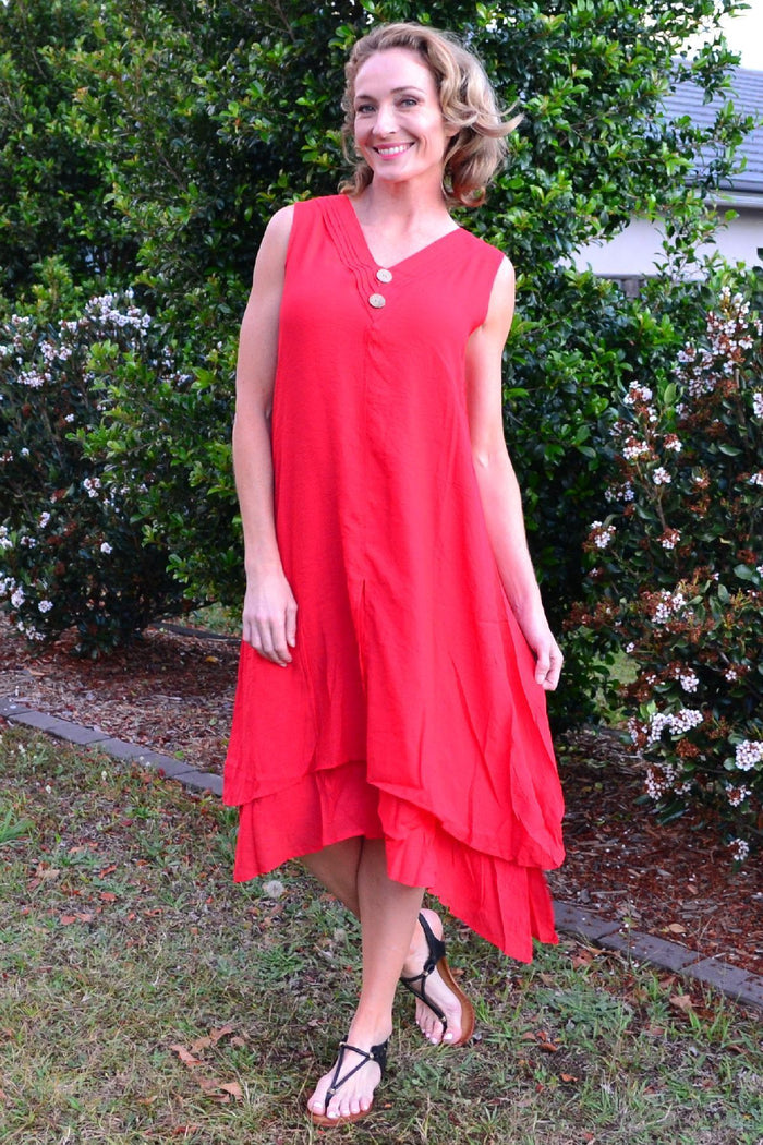 Red sleeveless coconut button tunic dress by La Mode, shown on a model, featuring a relaxed fit and stylish design.