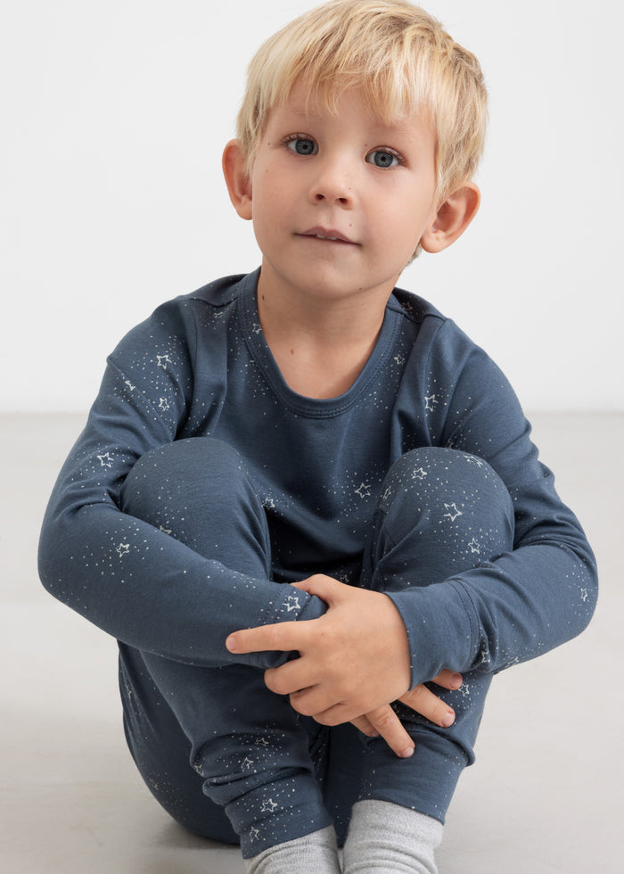 Boy wearing dark blue pajama set with star print