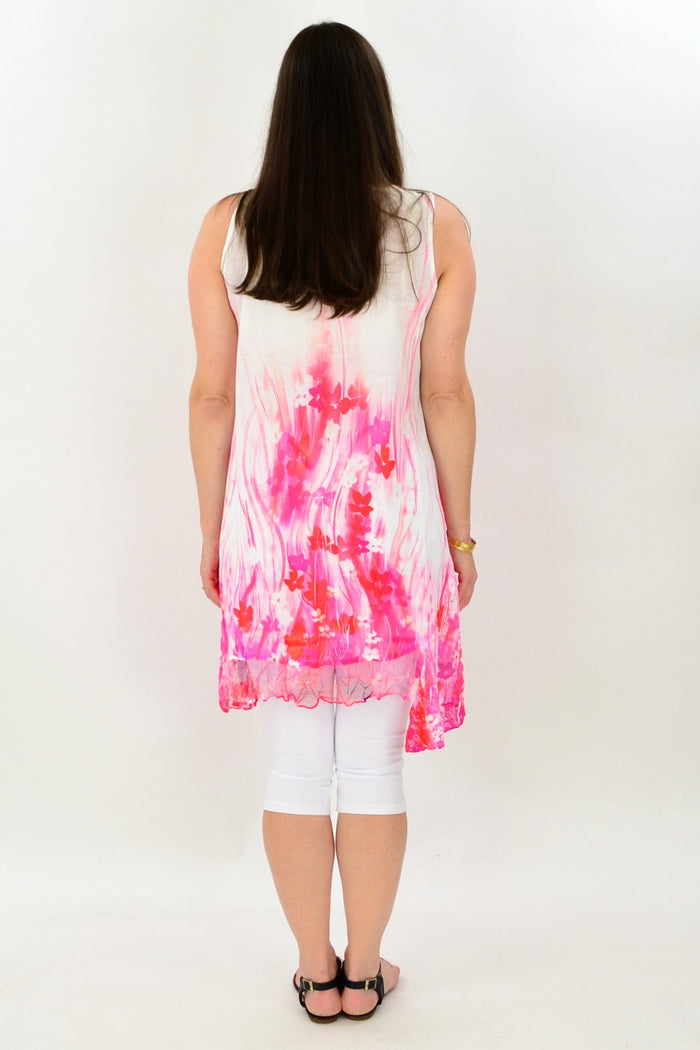 I Love Tunics Strawberries n Cream Tunic displayed on a hanger with floral background, showcasing its soft fabric and vibrant print.