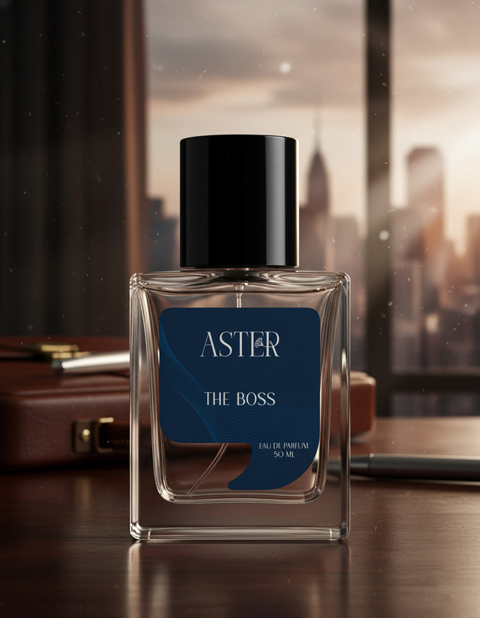 Aster The Boss perfume bottle on a reflective surface with a blurred cityscape background