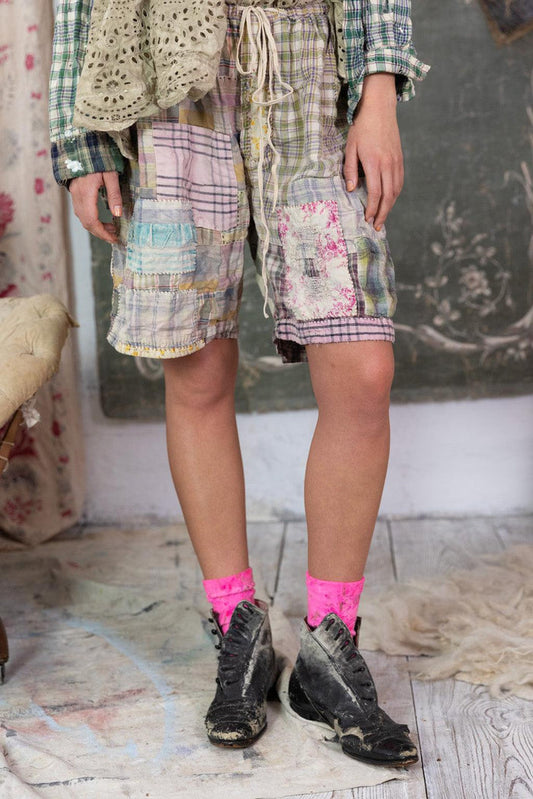 Magnolia Pearl patchwork artisan shorts with whimsical vintage style, model in pink socks and distressed boots